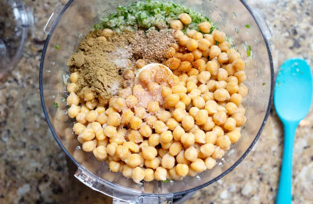 Chickpeas, herbs, and spices in the food proessor