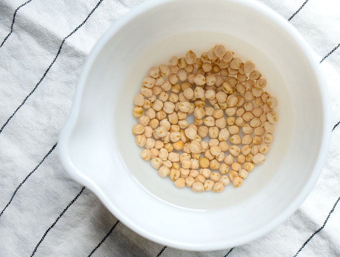 Dried chickpeas covered with water to soak overnight