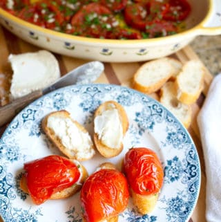 Slow-roasted tomatoes on top of crostini spread with goat cheese make for a beautiful and delicious appetizer.