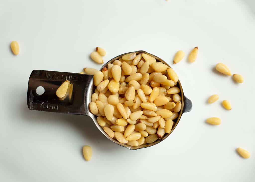 Pine nuts in a measuring cup