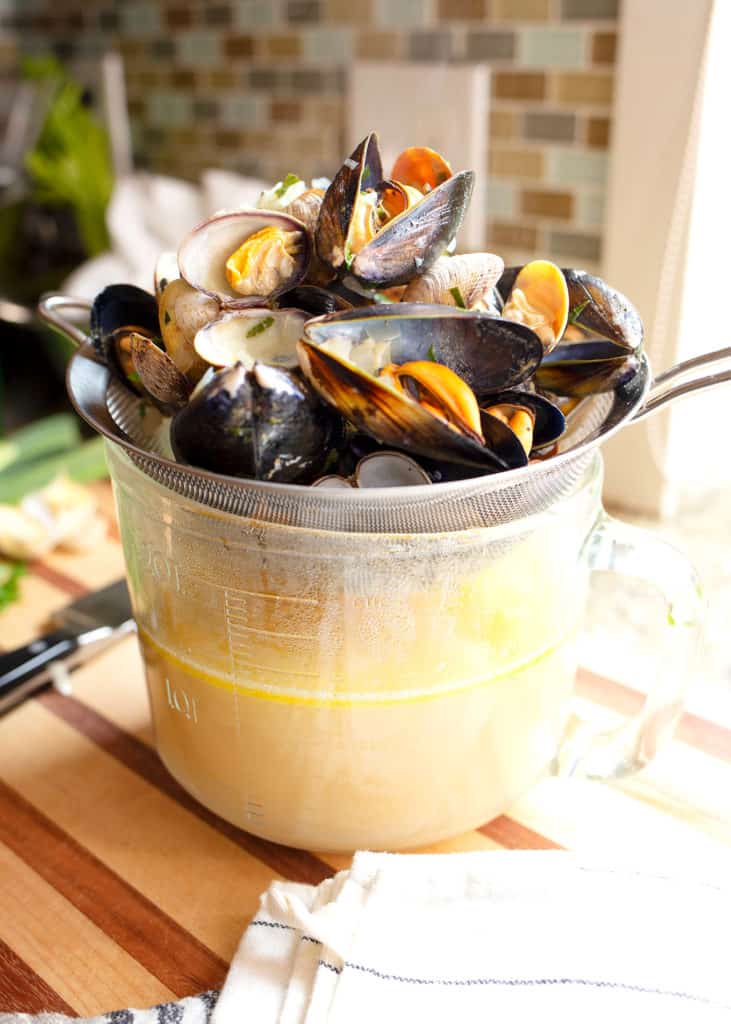 Mussels and clams strained into a measuring cup and preserved