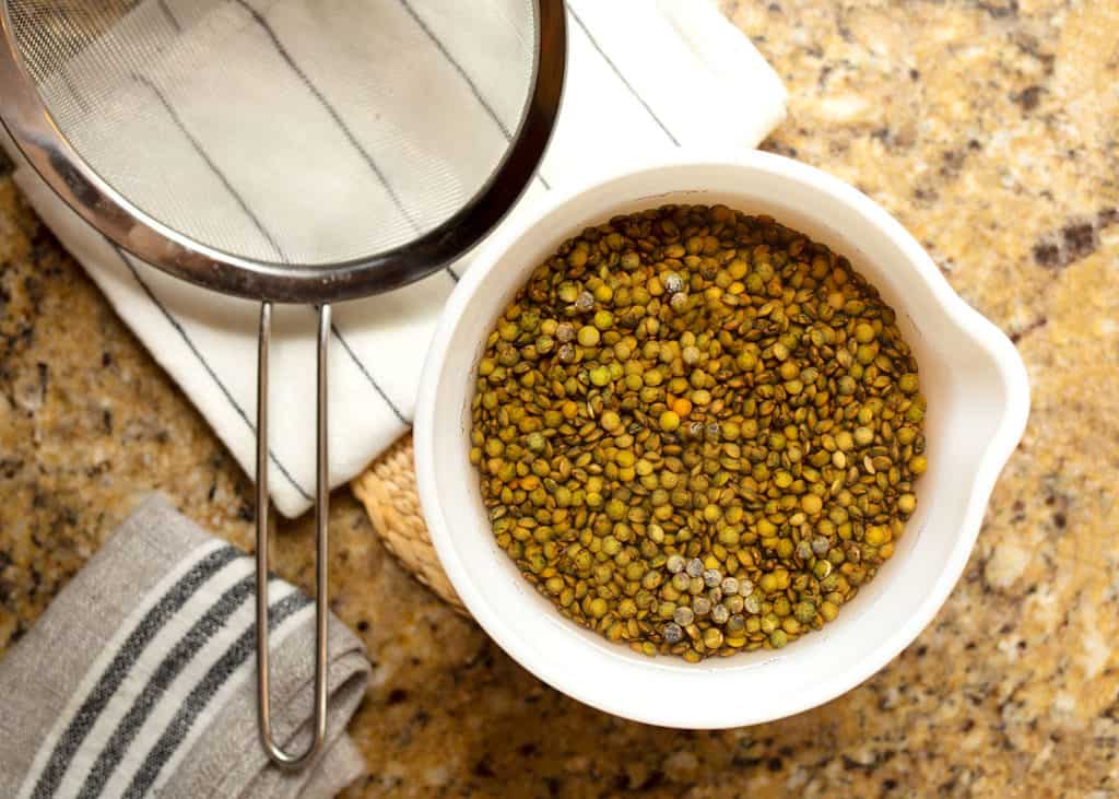 Soaked lentils in a bowl of water ready to be drained for the soup