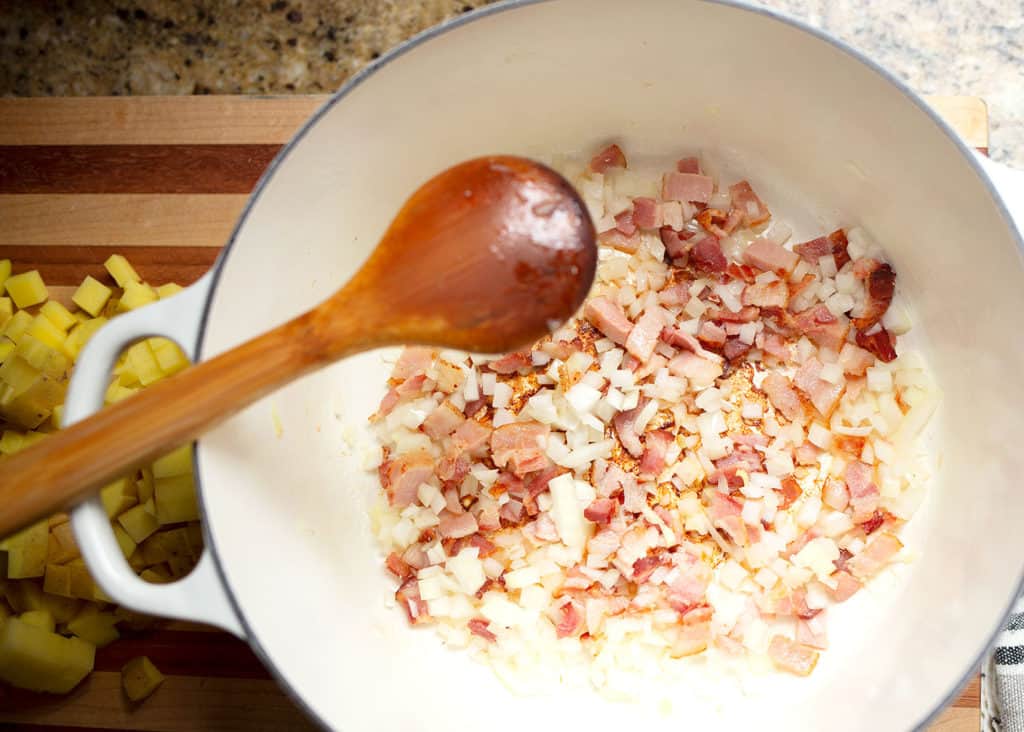 Onion and bacon in the soup pot browning