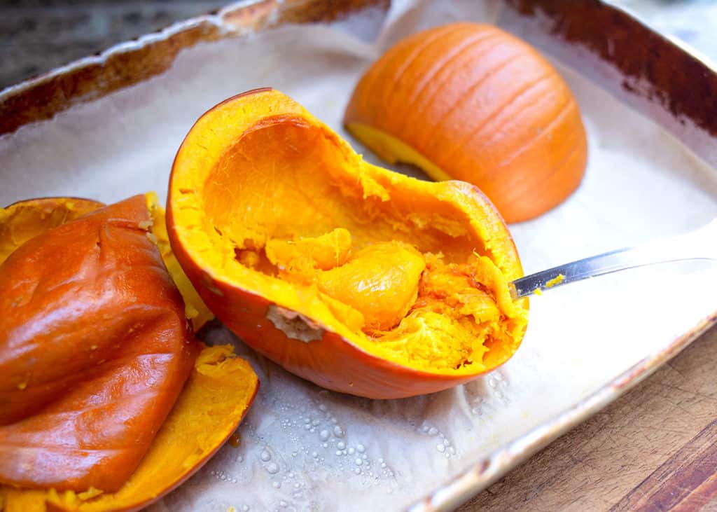 Use a spoon to scoop out the cooked insides of the sugar pumpkins