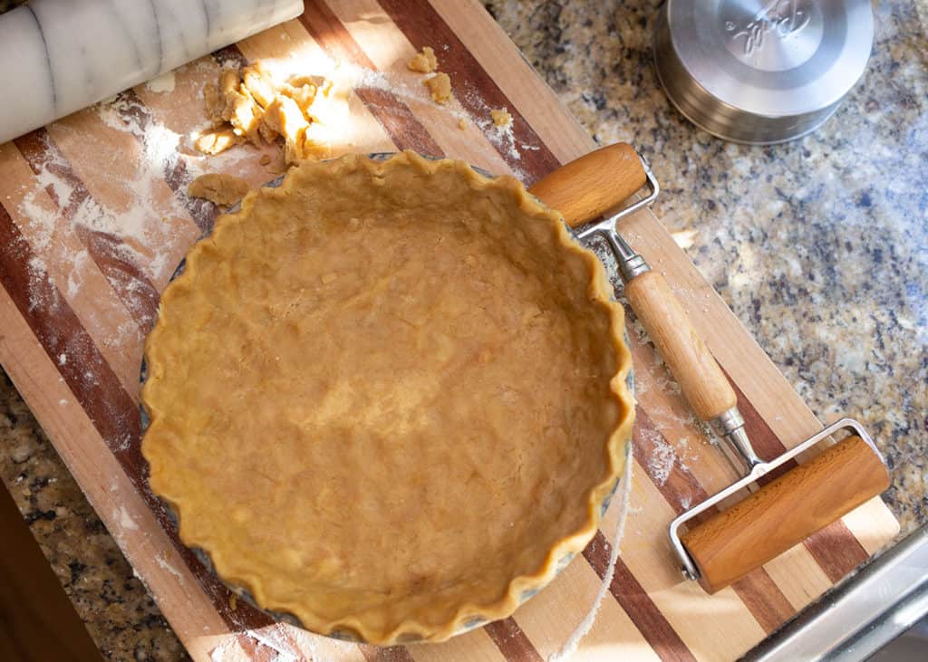 Rolled pie crust with a crimped edge in the pie plate