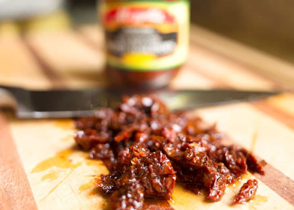 Chopped sundried tomatoes on cutting board