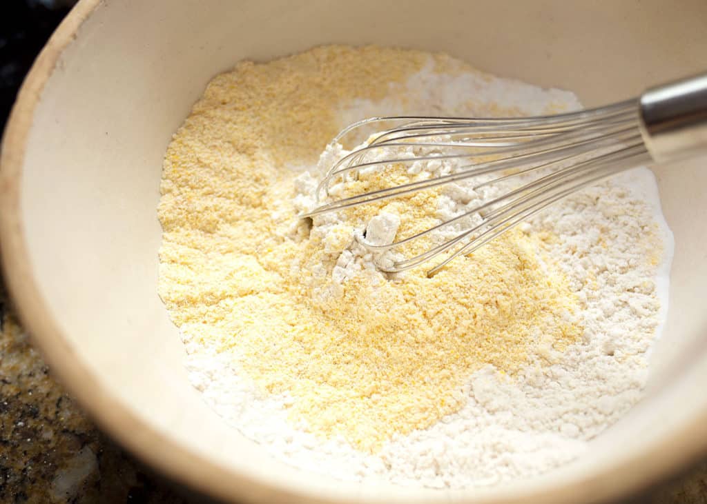 Cornmeal, flour, baking powder, baking soda, and salt whisked together in a large mixing bowl