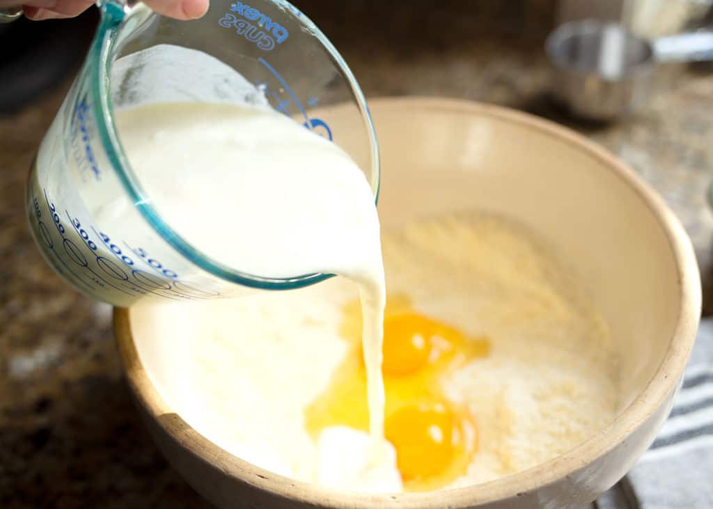 Pouring the buttermilk into the cornmeal mixture