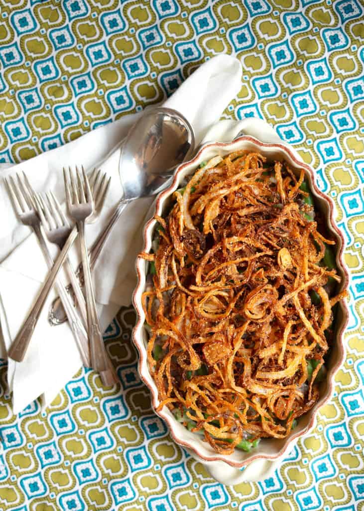 Fresh Green Bean Casserole with homemade fried onions on top in a pottery casserole dish
