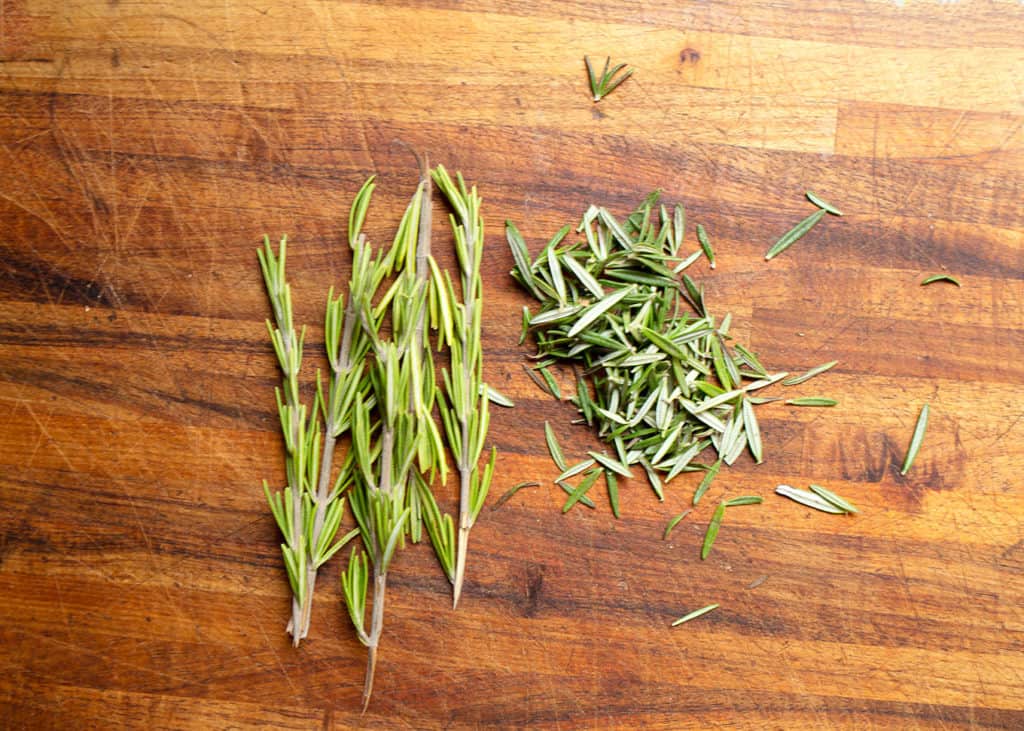 Fresh rosemary on the cutting board to chop small