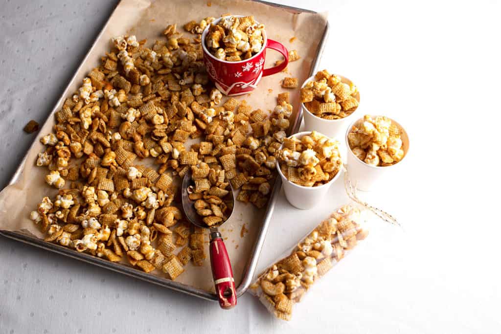 One red Christmas cup of caramel corn, three paper cups and one gift bag