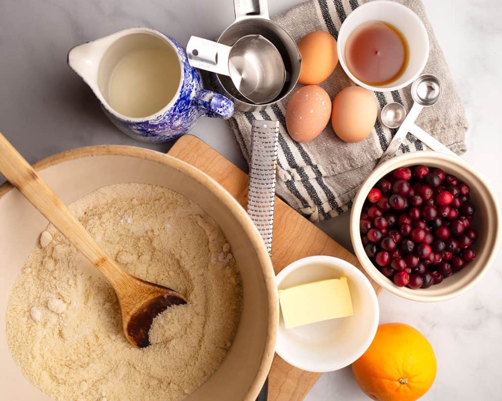 Ingredients for Cranberry Orange Muffins measured out in various dishes