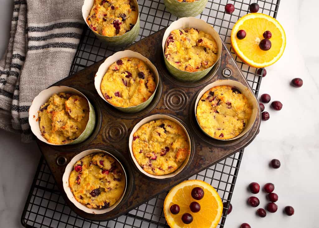 Tray of muffins with orange slices and cranberries