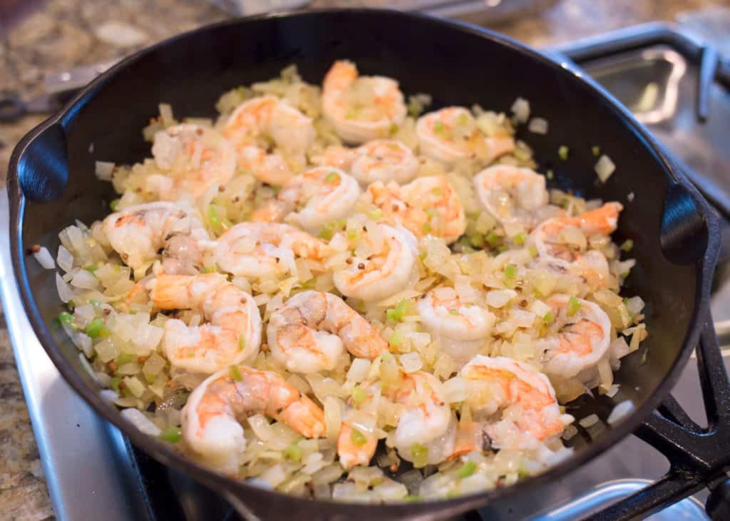 Cooked shrimp in the skillet with onions, garlic, and jalapeno peppers