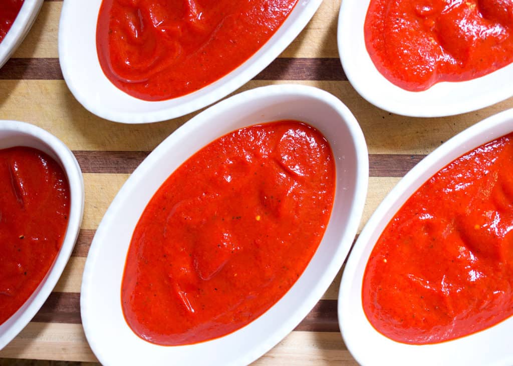 Roasted red pepper sauce in individual baking dishes