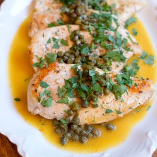Platter of Chicken Piccata garnished with Parsley