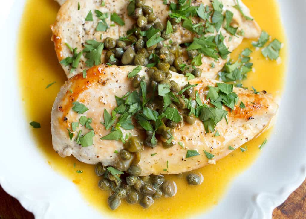 Close up of Chicken Piccata floating in the buttery lemon sauce