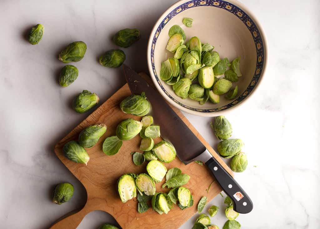 Cutting the brussels sprouts on a cuting board