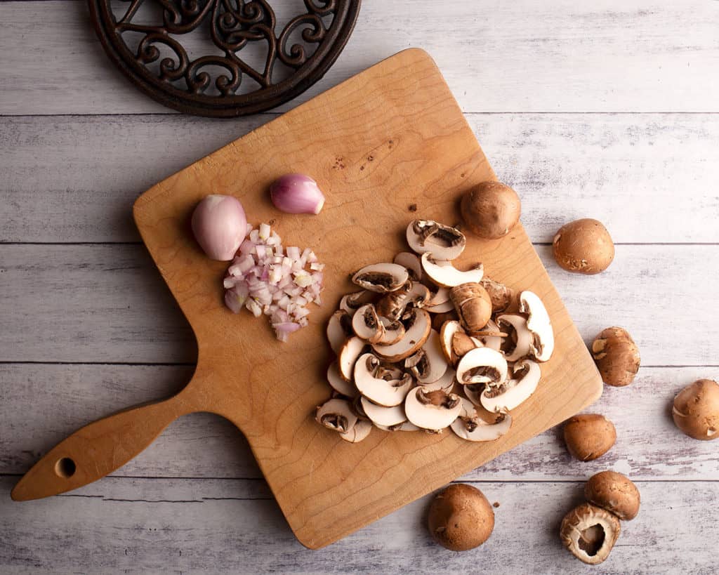 Mushrooms and shallots on a cutting board