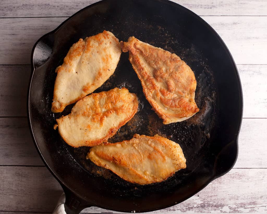 Dredged and cooked chicken in cast iron