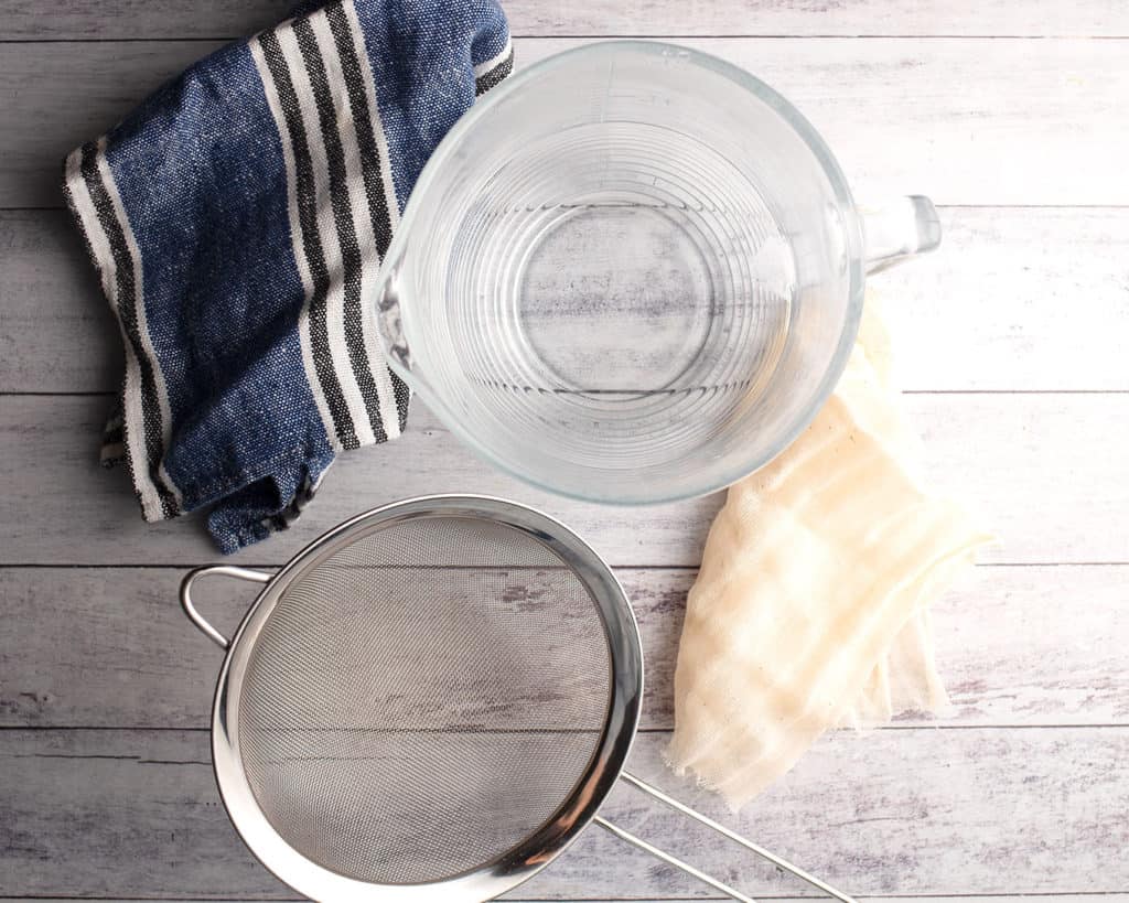 Large measuring cup, strainer, and cheesecloth