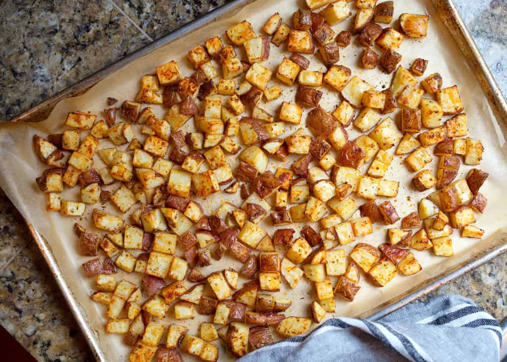 Roasted potatoes on parchment lined baking sheet