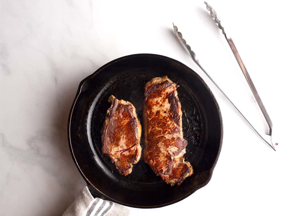 Steaks seared in cast iron skillet