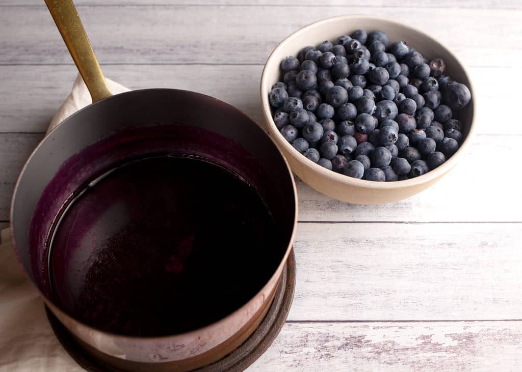 Blueberry jelly and fresh berries for pie topping