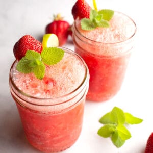 2 glasses of Strawberry Mint Agua Fresca with garnishes