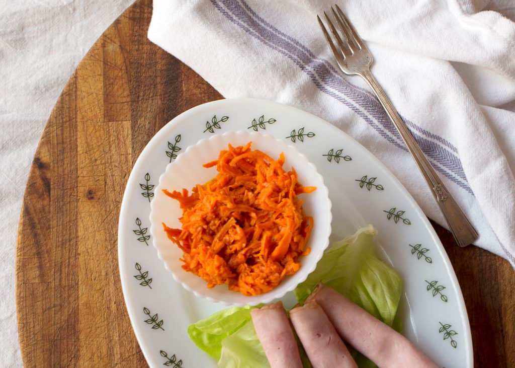 Small bowl of carrot salad with vinaigrette
