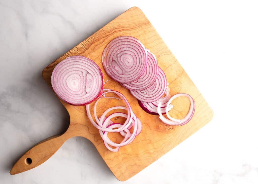 sliced red onion on cutting board