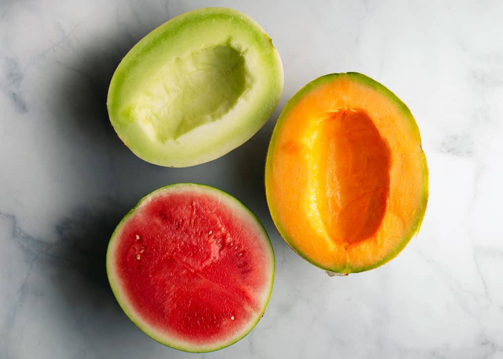 Cantaloupe, honeydew, and watermelon cut in half