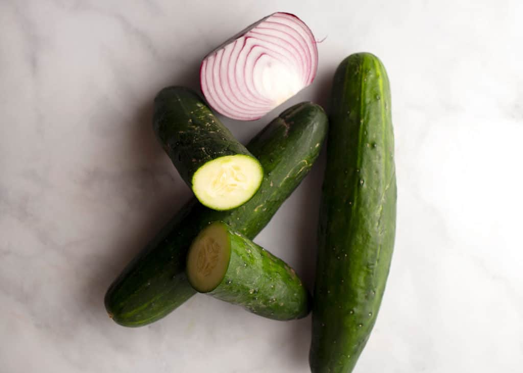 three cucumbers and half of a red onion