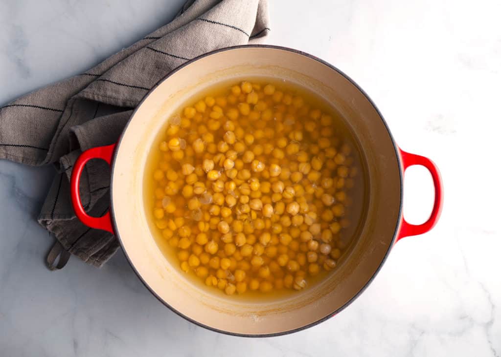Cooked chickpeas in an enameled cast iron pot