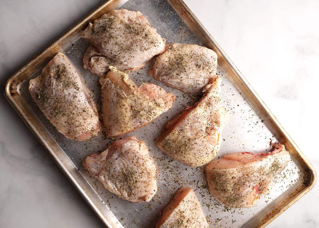Chicken pieces seasoned with salt, pepper, and oregano
