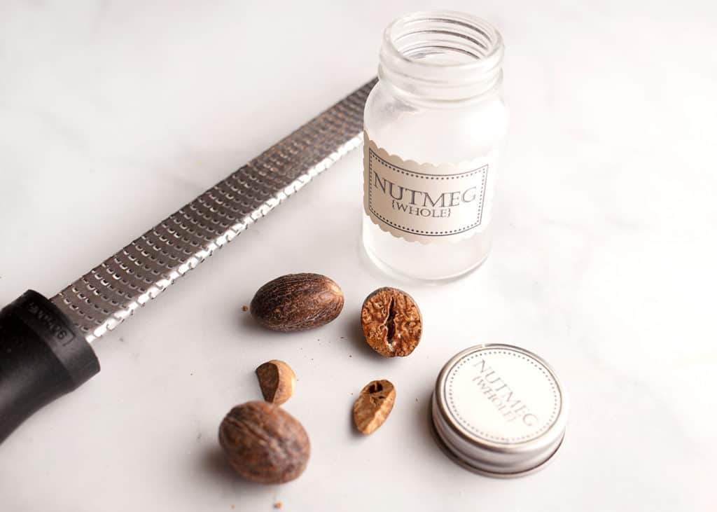 Whole nutmeg with microplane and spice jar