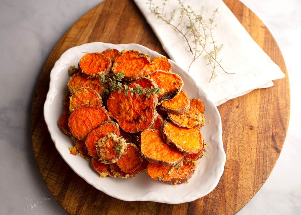 Herb & Parmesan Crusted Sweet Potato Rounds on a platter