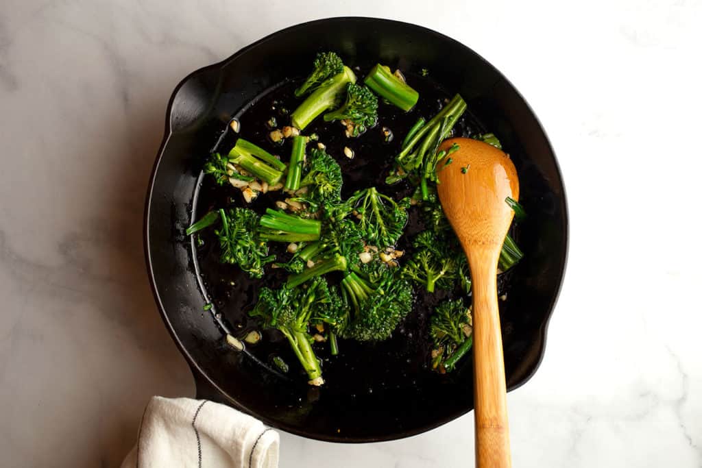 Broccolini added to the skillet to saute