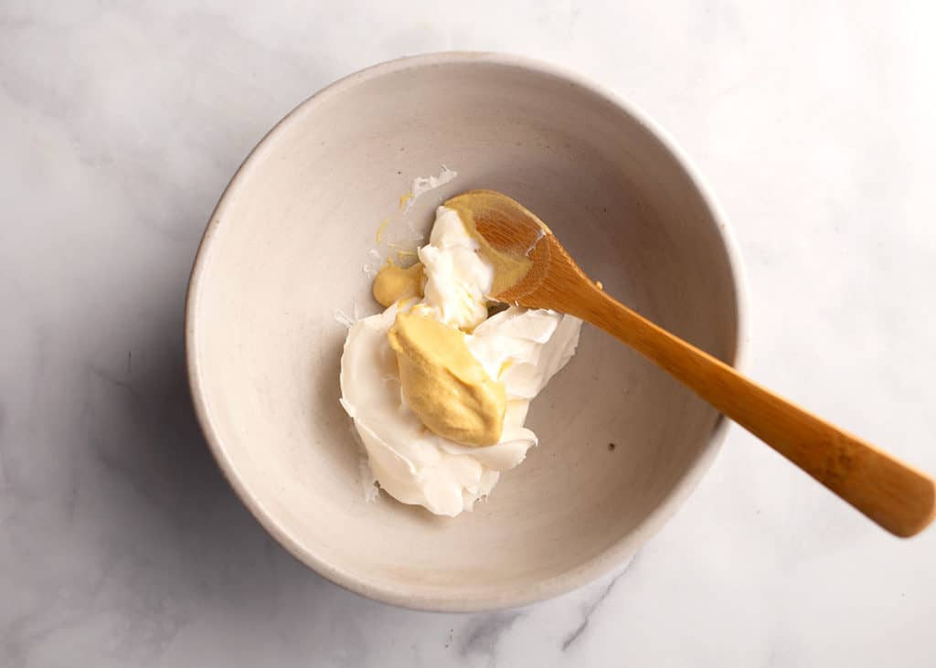 Creme fraiche and dijon mustard in a bowl to mix