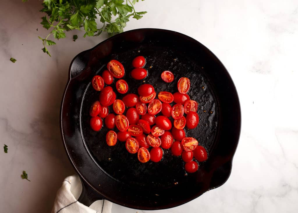 Sauteeing tomatoes in a cast iron skillet