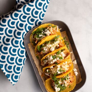Five Chicken Tinga Tacos dressed on a platter