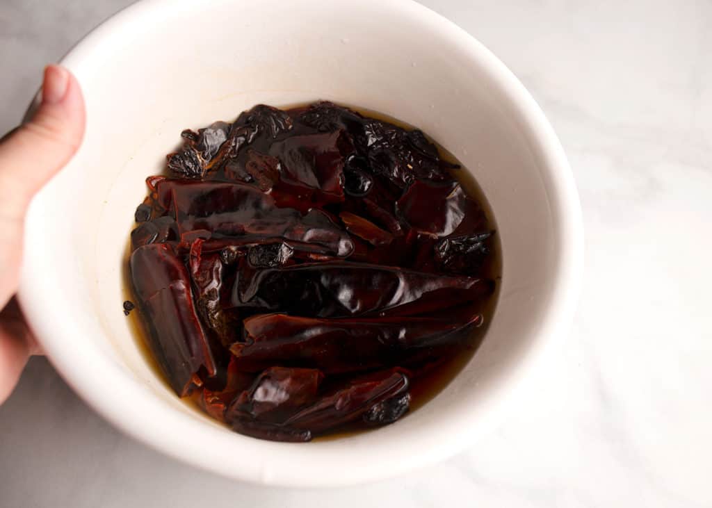 Soaking dried peppers in hot water