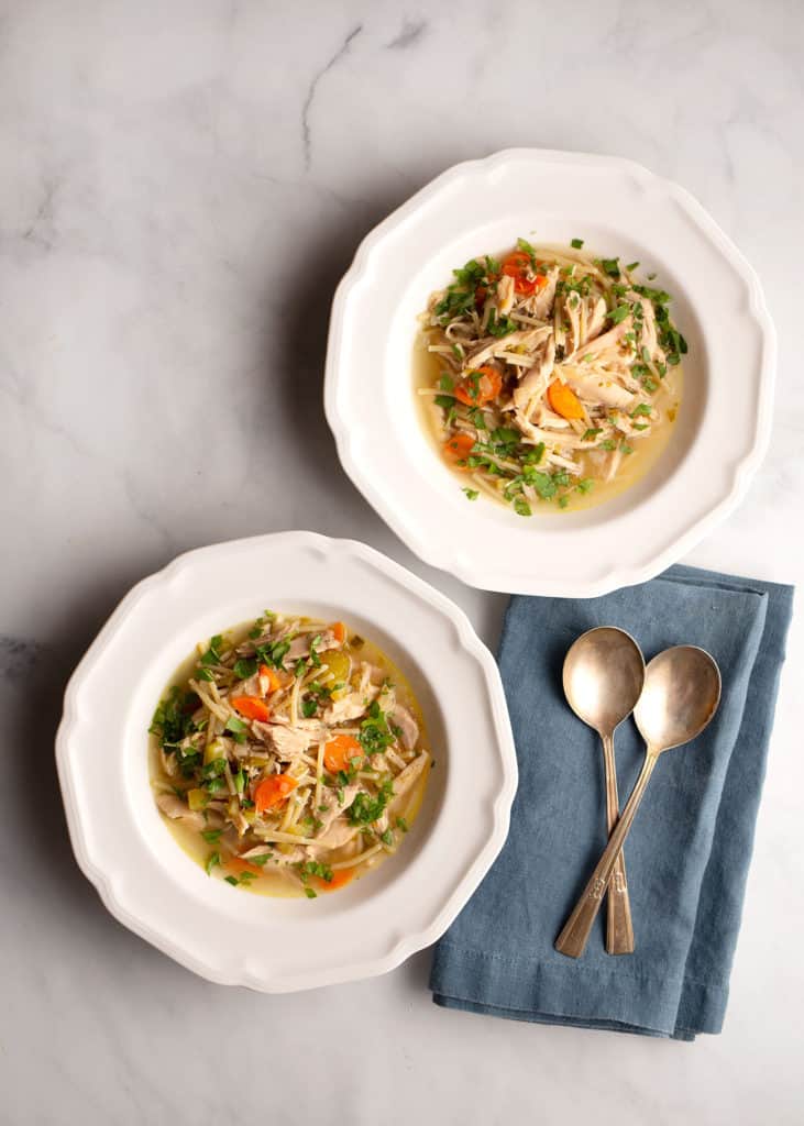 Two servings of Chicken Noodle Soup in soup plates