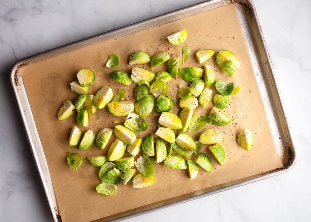 Cut Brussels sprouts with oil, salt, & pepper on baking sheet