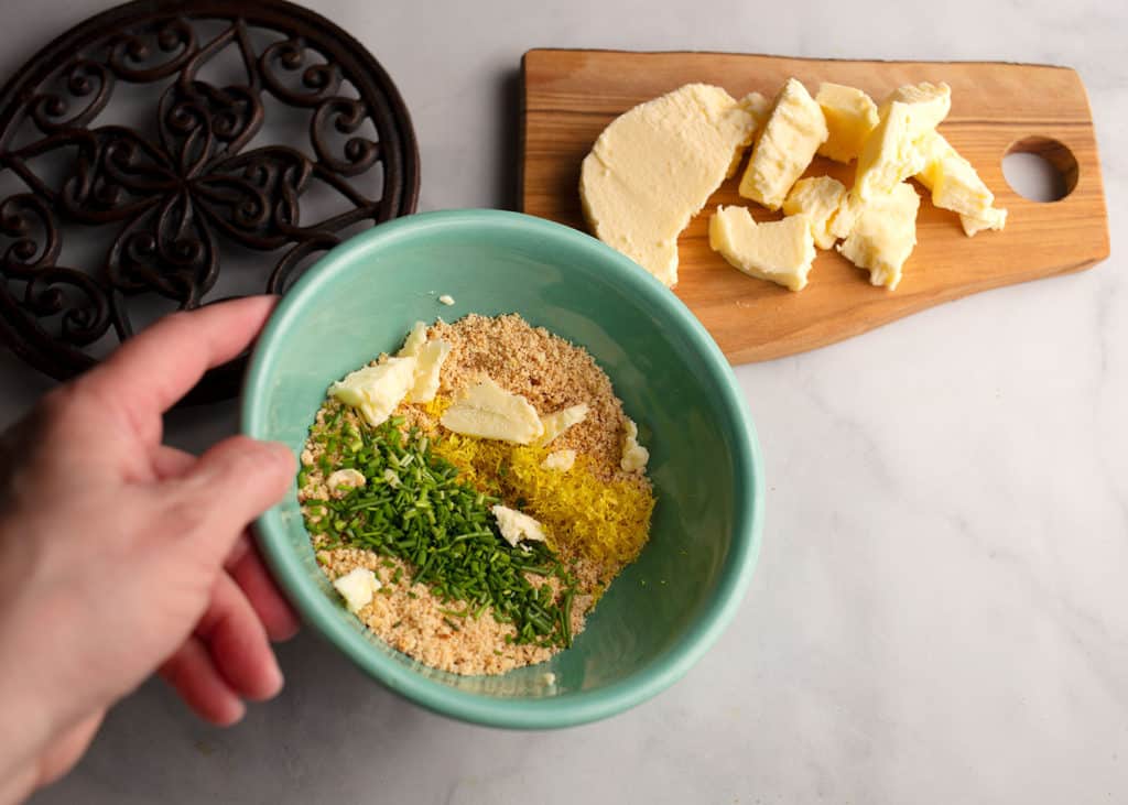 Crushed nuts, butter, chives, and lemon zest