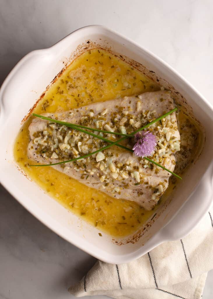 Butter baked halibut with fresh chives and blossoms