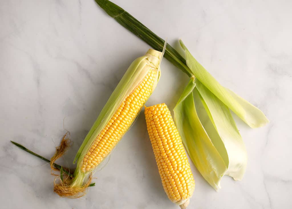 Shucking fresh corn on the cob