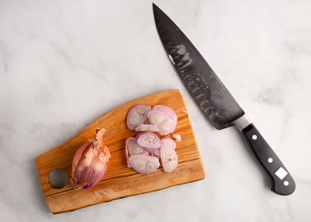 Sliced shallots on a cutting board