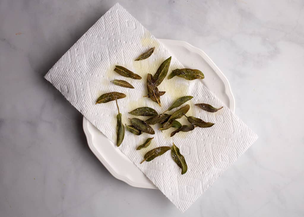 Fried sage leaves on a paper towel
