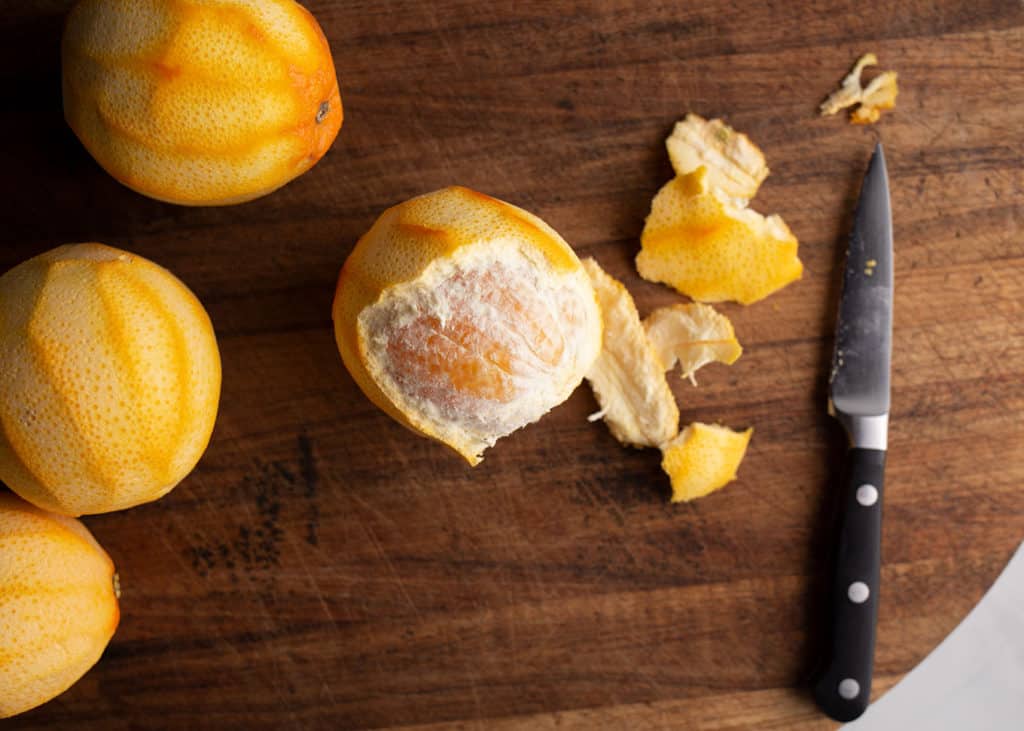 Use a paring knife to remove the thick pith from the orange